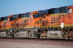 BNSF 6627 rolls eastbound with BNSF 7548 in front and BNSF 6620 behind her.